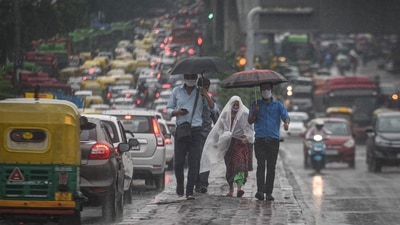 People walking along a divider next to congested traffic during heavy rain at Shadipur in New Delhi on July 13. Tuesday’s onset over Delhi is the most delayed arrival of monsoon in the Capital since 2002 -- that year, the first of the showers was on July 19. The usual date, IMD says, for monsoon onset in Delhi is June 27. (Sanchit Khanna / HT Photo) People walking along a divider next to congested traffic during heavy rain at Shadipur in New Delhi on July 13. Tuesday’s onset over Delhi is the most delayed arrival of monsoon in the Capital since 2002 -- that year, the first of the showers was on July 19. The usual date, IMD says, for monsoon onset in Delhi is June 27. (Sanchit Khanna / HT Photo)