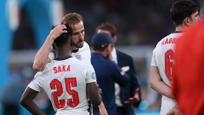 England's Harry Kane, center, consoles Bukayo Saka after the penalty shootout of the Euro 2020 soccer final match between England and Italy at Wembley stadium in London, Sunday, July 11, 2021. (AP) England's Harry Kane, center, consoles Bukayo Saka after the penalty shootout of the Euro 2020 soccer final match between England and Italy at Wembley stadium in London, Sunday, July 11, 2021. (AP)
