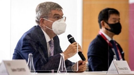 IOC President Thomas Bach, left, speaks to Tokyo 2020 President Seiko Hashimoto, not in photo, during their meeting at the Tokyo 2020 Headquarters. (AP)
