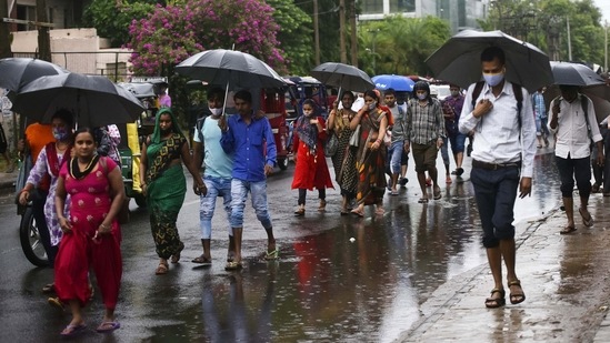 Industrial workers waling with umbrellas at Udyog Vihar during the first monsoon rain in Gurugram on July 12. Just before it was to cover Delhi (along with Haryana, Uttar Pradesh, Rajasthan, and Punjab), the monsoon entered what IMD described as a “break spell” from June 29 to July 8. This “break spell," which is not unusual for monsoon weather systems, ended up eventually causing it to drop behind schedule.(Vipin Kumar / HT Photo)