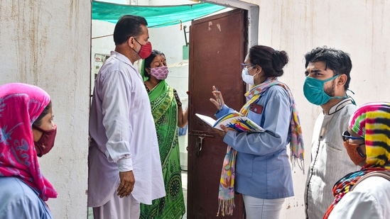 A medical team conducts a door-to-door survey to detect Covid-19 cases after a Delta Plus variant case was found in Rajasthan.(PTI)