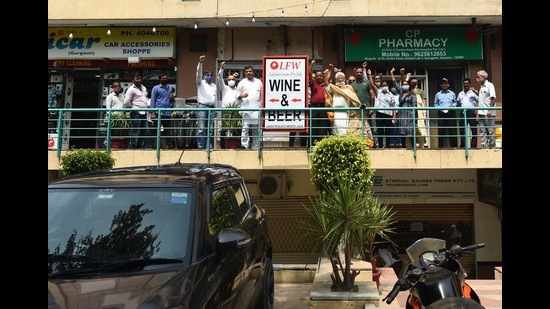 Around a 100 residents gathered at the liquor shop on Wednesday morning to register their protest. (Vipin Kumar/HT PHOTO)