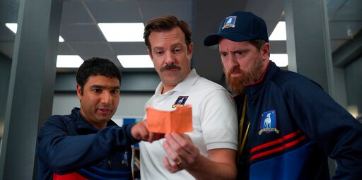 This image released by Apple TV Plus shows Nick Mohammed, from left, Jason Sudeikis, and Brendan Hunt in "Ted Lasso." The program was nominated for an Emmy Award for outstanding comedy series. (Apple TV Plus via AP)(AP)
