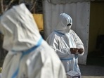 Health workers in PPE coveralls working at a temporary coronavirus testing facility set up at Sarai Kale Khan in New Delhi. Health workers in PPE coveralls working at a temporary coronavirus testing facility set up at Sarai Kale Khan in New Delhi.