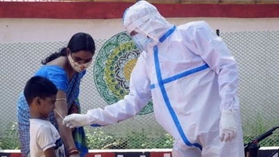 A health worker collects a nasal swab sample from a boy for Covid-19 testing at the urban primary health centre, in Bhubaneswar. (HT Photo) A health worker collects a nasal swab sample from a boy for Covid-19 testing at the urban primary health centre, in Bhubaneswar. (HT Photo)