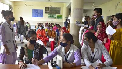 Doctors running a parallel OPD at a common hall in civil hospital, Ludhiana, on Thursday. (Gurpreet Singh/HT)