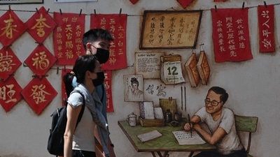 A couple walk past wall murals in a back alley in the Chinatown area of Singapore. (AP file photo) A couple walk past wall murals in a back alley in the Chinatown area of Singapore. (AP file photo)