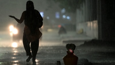 A woman walks along a street during heavy rainfall in Chennai, on Wednesday. (AFP Photo) A woman walks along a street during heavy rainfall in Chennai, on Wednesday. (AFP Photo)