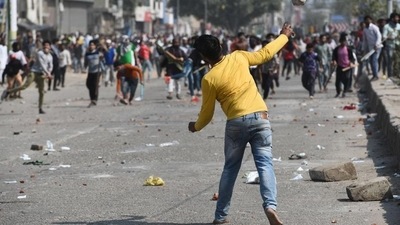 A protester hurl stones during a clash between anti CAA and pro CAA demonstrations, at Bhajanpura in New Delhi. (Sanchit Khanna/HT FILE PHOTO) A protester hurl stones during a clash between anti CAA and pro CAA demonstrations, at Bhajanpura in New Delhi. (Sanchit Khanna/HT FILE PHOTO)