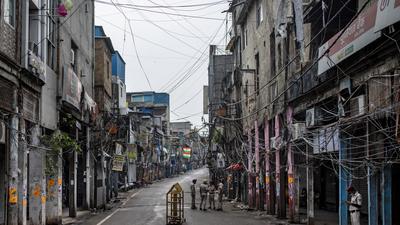Indian Home Guard personnel stand in an empty street of Sadar Bazar wholesale market which is partially closed for violating COVID-19 guidelines in New Delhi, India, Tuesday, July 13, 2021. (AP Photo/Altaf Qadri) (AP) Indian Home Guard personnel stand in an empty street of Sadar Bazar wholesale market which is partially closed for violating COVID-19 guidelines in New Delhi, India, Tuesday, July 13, 2021. (AP Photo/Altaf Qadri) (AP)