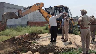 Demolition of illegal structures in progress in Giaspura area of Ludhiana on Thursday. (HT Photo)