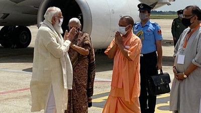 Uttar Pradesh Governor Anandiben Patel, CM Yogi Adityanath, and other dignitaries welcome PM Modi in Varanasi on Thursday. (PTI)