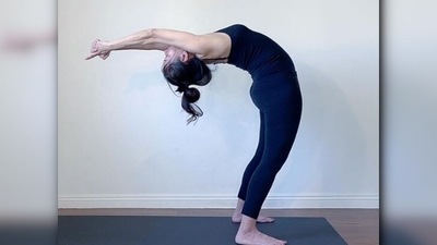 Hasta Uttanasana or raised arm yoga pose: Stand straight and raise your arms with folded hands. Slowly bend back with that pose and hold for some time.  (Instagram/@nikkiwellsyoga)