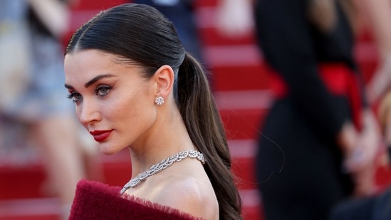 Amy wore the couture gown that had micro ruffle detailing all over, a flowing trail, a big flouncy skirt and off-shoulder style corset as she walked the red carpet in Cannes for the premiere of A Felesegem Tortenete (The Story of My Wife) . (AFP)