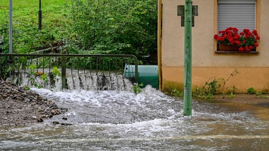 Emergency workers struggled to evacuate people in endangered buildings and two firemen were killed in the line of duty in the towns of Altena and Wedohl.(AFP) Emergency workers struggled to evacuate people in endangered buildings and two firemen were killed in the line of duty in the towns of Altena and Wedohl.(AFP)