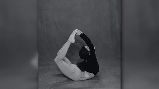 Dhanurasana or bow pose: Lie down on the ground with your stomach flat on the floor and bend your knees towards your hips and hold your ankles. Push the body back keeping your face up. Hold this pose as long as you can.(Unsplash)