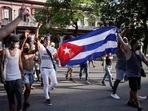 People hold Cuba's national flag during protests against and in support of the government, amidst the coronavirus disease outbreak in Havana, Cuba.