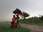 Children out during heavy rain at Yamuna River Bank in New Delhi(Raj K Raj / Hindustan Times)