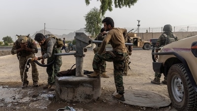 Members of Afghan Special Forces regroup after heavy clashes with Taliban during the rescue mission of a policeman besieged at a check post, in Kandahar province, Afghanistan on July 13. (Danish Siddiqui / REUTERS)