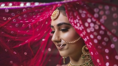 Disha had her hair tied back in a tight bun and it was covered with her mesh dupatta. She wore a huge gold choker style necklace that had intricate designs and green beads all over it, she also wore a teeka, earrings that needed to be secured into her hair (Instagram/IsraniPhotography) Disha had her hair tied back in a tight bun and it was covered with her mesh dupatta. She wore a huge gold choker style necklace that had intricate designs and green beads all over it, she also wore a teeka, earrings that needed to be secured into her hair (Instagram/IsraniPhotography)