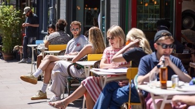 People dine outdoors at Broadway Market in Hackney, London, UK. (Bloomberg) People dine outdoors at Broadway Market in Hackney, London, UK. (Bloomberg)