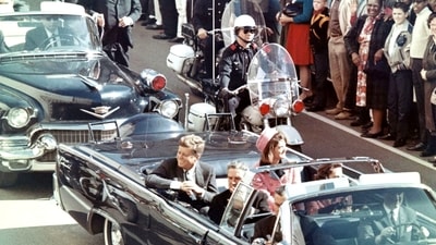 John F Kennedy had been adviced by his security staff against travelling in an open motorcar. John F Kennedy had been adviced by his security staff against travelling in an open motorcar.