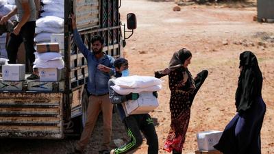 A worker holds bags and a box of humanitarian aid in Idlib, Syria. (REUTERS) A worker holds bags and a box of humanitarian aid in Idlib, Syria. (REUTERS)