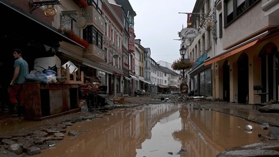 A resident stands next to damaged furniture in a flooded street in Ahrweiler-Bad Neuenahr, western Germany, on July 15, 2021. (AFP) A resident stands next to damaged furniture in a flooded street in Ahrweiler-Bad Neuenahr, western Germany, on July 15, 2021. (AFP)