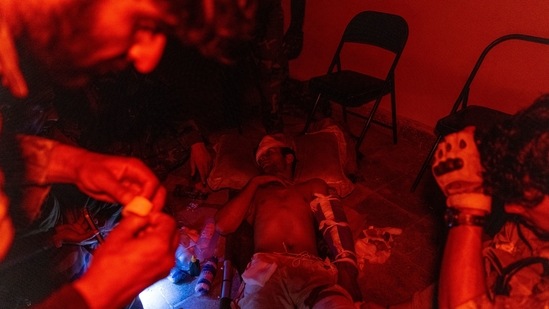 Members of the Afghan Special Forces tend to an Afghan National Army soldier injured during a firefight with Taliban, who tried to attack a district centre in Kandahar province, Afghanistan on July 12.(Danish Siddiqui / REUTERS)