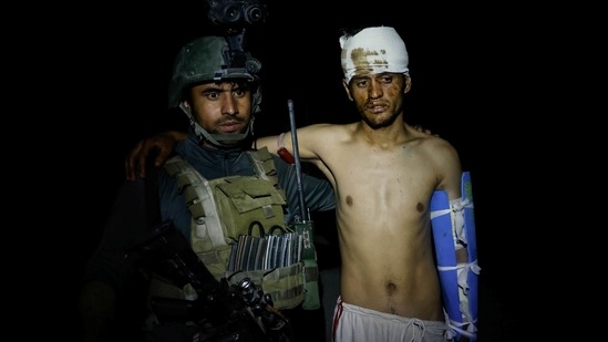A member of the Afghan Special Forces evacuates an Afghan National Army soldier injured during a firefight with Taliban, in Kandahar province, Afghanistan on July 12.(Danish Siddiqui / REUTERS)