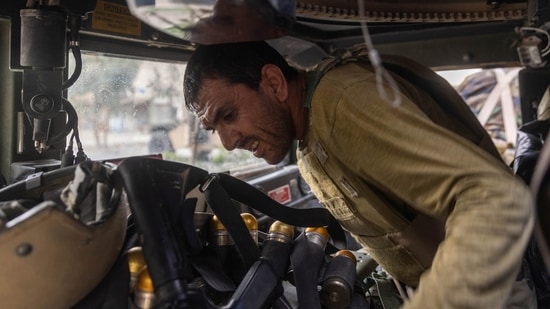 Members of Afghan Special Forces travelling in a humvee destroyed during heavy clashes with Taliban take cover during the rescue mission of a policeman besieged at a check post, in Kandahar province, Afghanistan on July 13.(Danish Siddiqui / REUTERS)