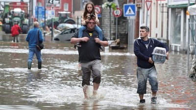People walking through an area affected by floods in Pepinster, Belgium on July 16. Scientists can’t yet say for sure whether climate change caused the flooding, but they insist that it certainly exacerbates the extreme weather that has been on show from the western U.S. and Canada to Siberia to Europe’s Rhine region, AP reported. (Yves Herman / REUTERS)