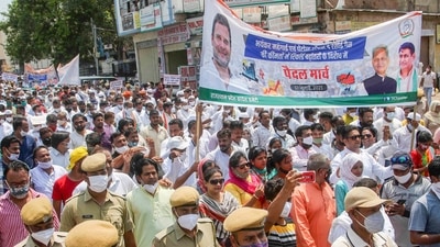 Congress Party activists take out a march as they protest against the hike in fuel and LPG prices, in Jaipur on July 17, 2021. (PTI Photo)