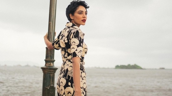 Photos: Sobhita Dhulipala poses for Gucci in pixie 5 The silk dress features a contrasting ivory poppy print set against a black background and an adjustable belt with a gold buckle which has the 'GG' logo on the front. (Instagram)