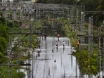 Commuters walk on waterlogged railway tracks following heavy rain, at Kurla in Mumbai on July 18. Several areas in the city have been flooded after heavy rainfall over the last 24 hours and suburban train services were also disrupted, crippling movement.(Kunal Patil / PTI) Commuters walk on waterlogged railway tracks following heavy rain, at Kurla in Mumbai on July 18. Several areas in the city have been flooded after heavy rainfall over the last 24 hours and suburban train services were also disrupted, crippling movement.(Kunal Patil / PTI)
