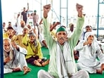 Farmers shout slogans during their protest against the three farms laws, at the Ghazipur border, in Delhi. 