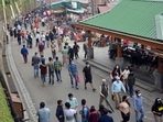 Tourists wander in a crowded market at mall road, in Shimla on Saturday.