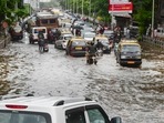 Commuters wade through a waterlogged road at Dadar after a monster thunderstorm caused heavy rains in Mumbai and adjoining areas on Sunday.(PTI) Commuters wade through a waterlogged road at Dadar after a monster thunderstorm caused heavy rains in Mumbai and adjoining areas on Sunday.(PTI)