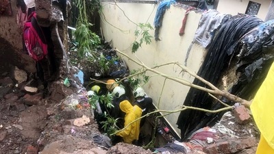 A National Disaster Response Force (NDRF) team inspects during a rescue operation after a wall collapsed in Chembur's Bharat Nagar due to a landslide, in Mumbai on July 18. (ANI) A National Disaster Response Force (NDRF) team inspects during a rescue operation after a wall collapsed in Chembur's Bharat Nagar due to a landslide, in Mumbai on July 18. (ANI)