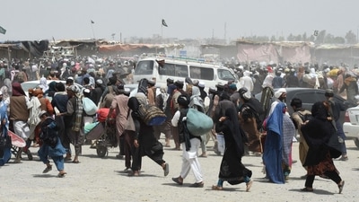 People rush towards a border crossing point in Pakistan's border town of Chaman on July 17, 2021. (AFP) People rush towards a border crossing point in Pakistan's border town of Chaman on July 17, 2021. (AFP)