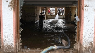 Locals dissolve the mud with water to remove it with a pump, on July 17, 2021, in a building in Insul near Bad Neuenahr-Ahrweiler, western Germany. (AFP) Locals dissolve the mud with water to remove it with a pump, on July 17, 2021, in a building in Insul near Bad Neuenahr-Ahrweiler, western Germany. (AFP)