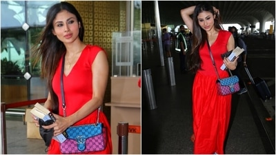 Mouni was clicked by the paparazzi outside the Mumbai airport today. She wore a bright red midi dress for her jet-set look. It is a fabulous off-duty ensemble that comes with a contemporary twist. (Varinder Chawla) Mouni was clicked by the paparazzi outside the Mumbai airport today. She wore a bright red midi dress for her jet-set look. It is a fabulous off-duty ensemble that comes with a contemporary twist. (Varinder Chawla)