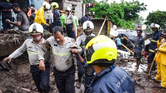 Firemen and rescue workers evacuate people after a wall collapsed on some shanties in Chembur's Bharat Nagar area due to a landslide, in Mumbai on July 18. Within the last 24 hours authorities have so far reported 11 incidents of houses or walls collapsing in the Mumbai area, Reuters reported.(Kunal Patil / PTI)