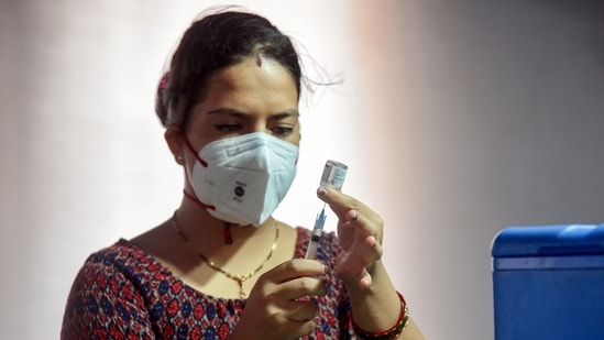 A healthcare worker fills a syringe with a dose of Covid-19 vaccine at a vaccination centre, in New Delhi on Saturday. (ANI Photo) A healthcare worker fills a syringe with a dose of Covid-19 vaccine at a vaccination centre, in New Delhi on Saturday. (ANI Photo)