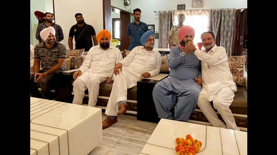 Congress leader Navjot Singh Sidhu being offered sweets by MLA Madan Lal Jalalpur as state cabinet minister Sukhjinder Singh Randhawa looks on, in Patiala on Sunday. (ANI)