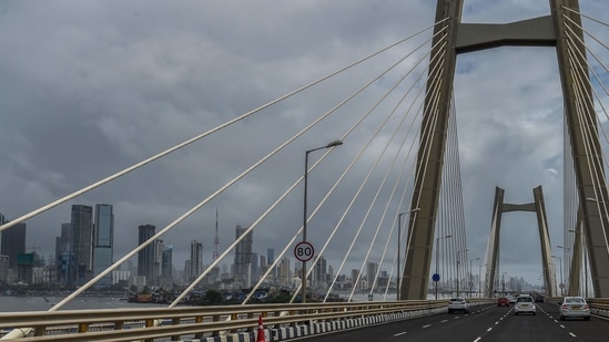 Dark clouds are seen over a city skyline from the Bandra to Worli sea link bridge in Mumbai on July 17, 2021. (AFP)