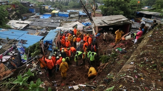 Rescue workers search for survivors after a residential house collapsed due to a landslide caused by heavy rainfall in Mumbai. (REUTERS/Niharika Kulkarni)