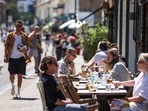 People dine outdoors at Broadway Market in Hackney, London, UK.