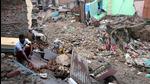 A man surrounded by the remains of the houses that collapsed by the flood due to heavy rainfall, in Jammu on Monday. (ANI) A man surrounded by the remains of the houses that collapsed by the flood due to heavy rainfall, in Jammu on Monday. (ANI)