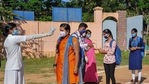 Students undergo temperature scanning as they arrive to appear in SSLC examination at a centre amid COVID-19 pandemic, in Chikmagalur, Karnataka (PTI). Students undergo temperature scanning as they arrive to appear in SSLC examination at a centre amid COVID-19 pandemic, in Chikmagalur, Karnataka (PTI).